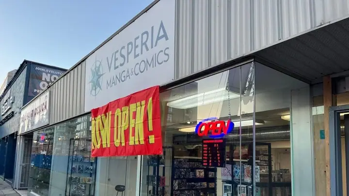 The Vesperia Comics storefront with its window displays and open sign.